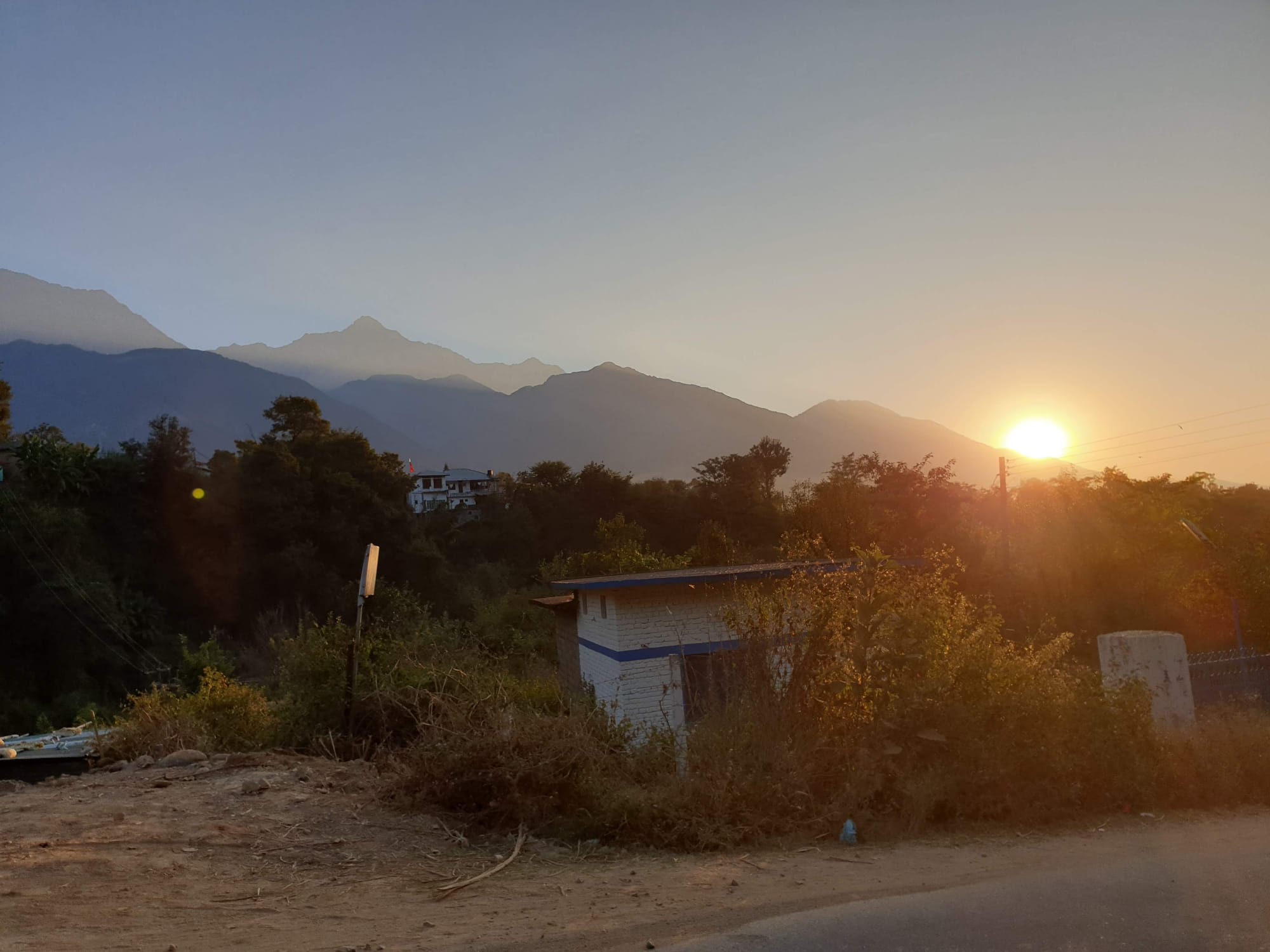 sun rising behind the mountains