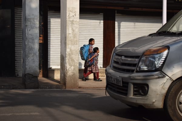 A car approaching towards two children